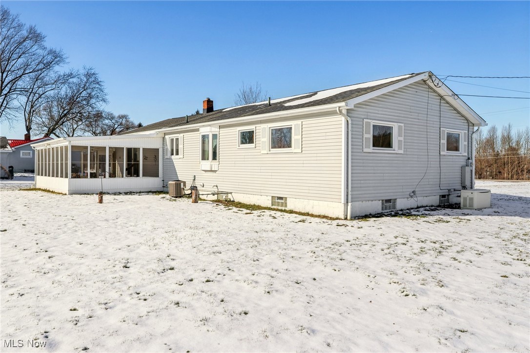 970 Eastern Road Doylestown, OH 44230 - Photo 37 of 49 Snow covered back of property featuring a sunroom and a chimney