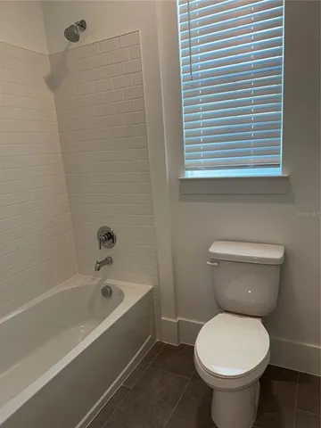 a bathroom with a toilet and a bathtub