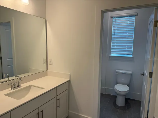 a white toilet sitting next to a bath tub