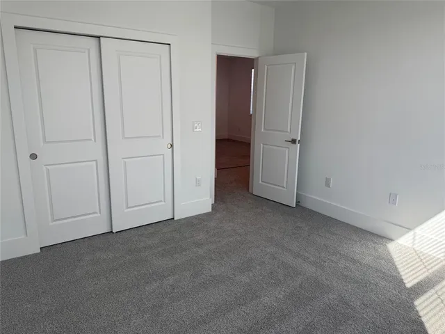 an empty room with closet area
