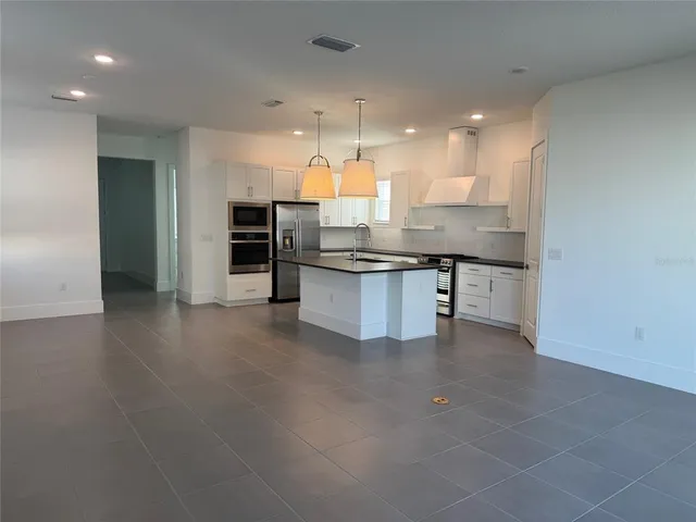 a kitchen with stainless steel appliances granite countertop a sink and cabinets