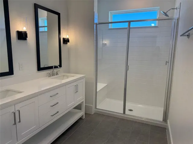 a bathroom with a double vanity sink and mirror