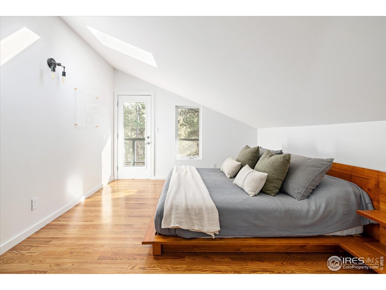 781 Cold Springs Road Boulder, CO 80302 - Photo 12 of 36 a bedroom with a bed and wooden floor