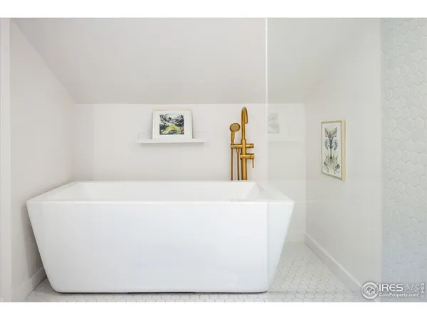 a white tub sitting next to a white wall