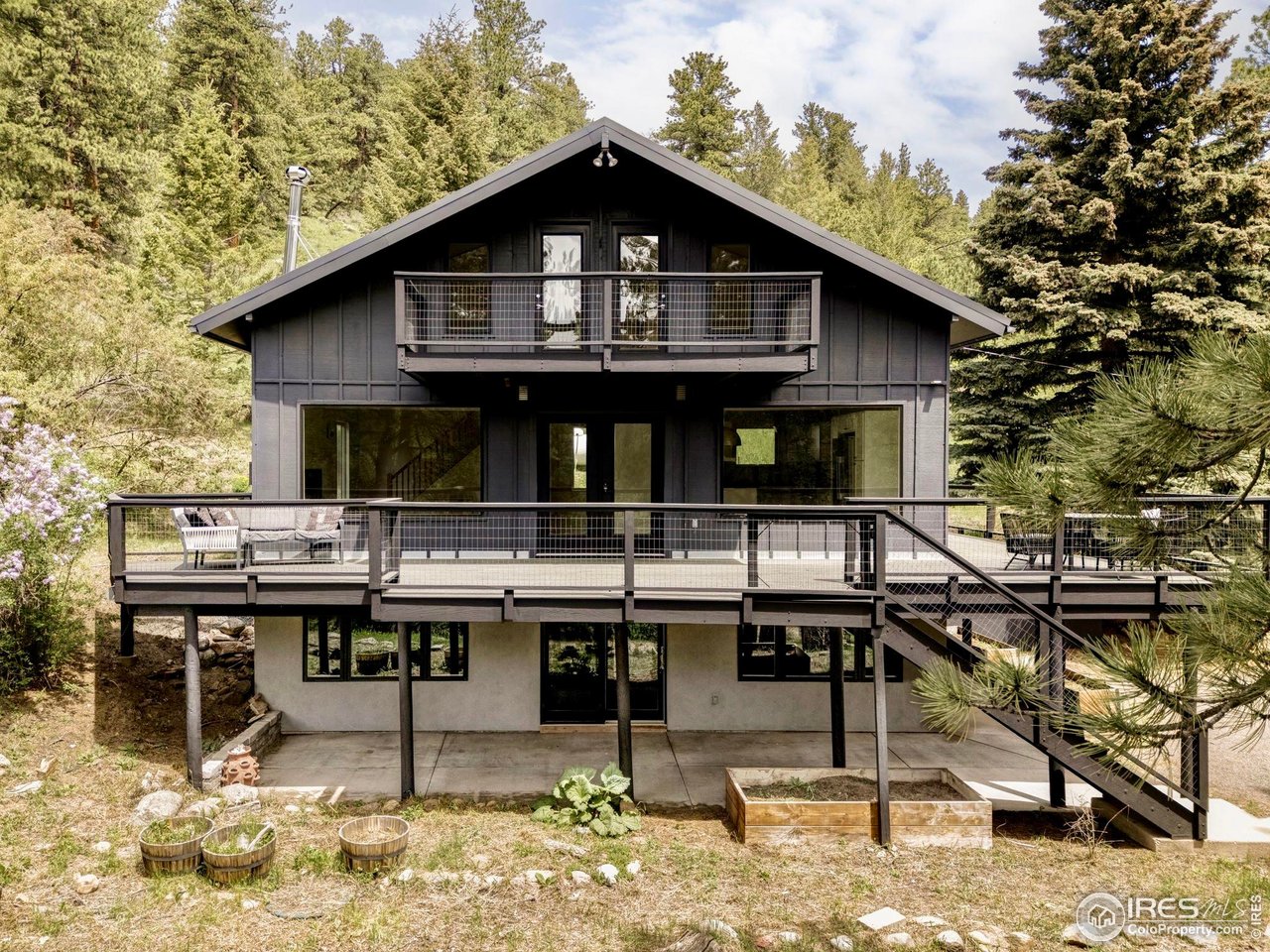 781 Cold Springs Road Boulder, CO 80302 - Photo 27 of 36 a view of a house with pool chairs and wooden fence