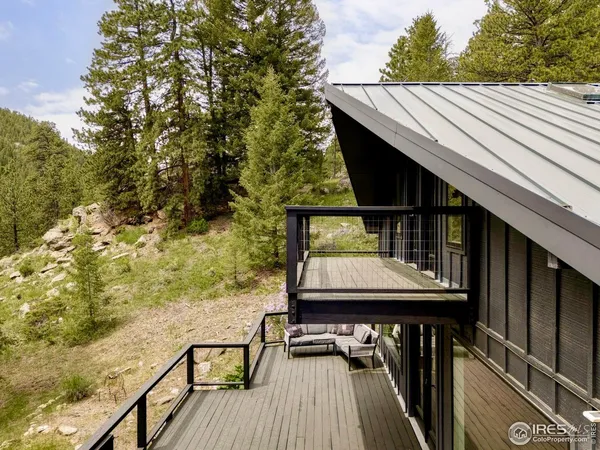 a view of balcony with wooden floor and outdoor seating