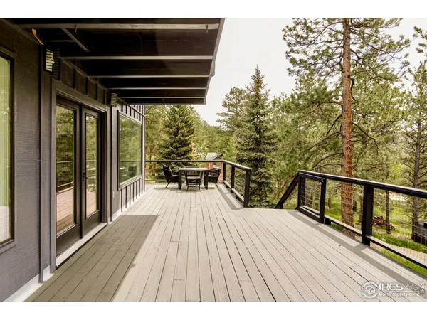 a view of balcony with wooden floor and seating space
