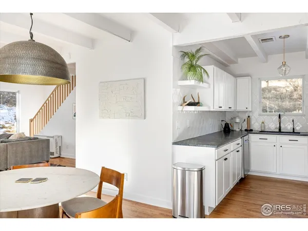 a kitchen that has a lot of cabinets a counter space and a window