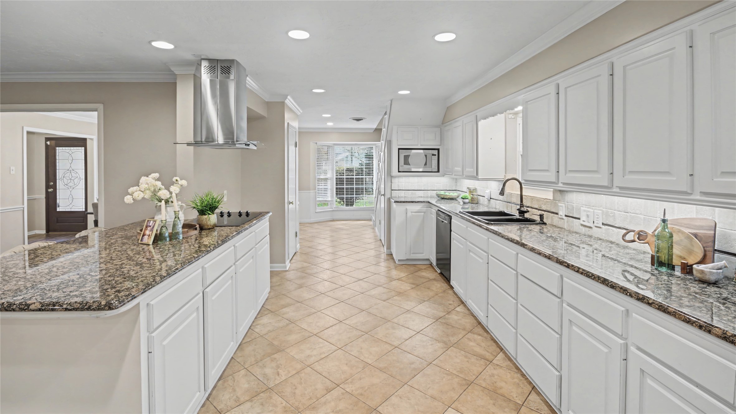 1431 Walnut Lane Houston, TX 77339 - Photo 2 of 44 Galley-style kitchen with extensive cabinet storage, granite countertops, and a peninsula for additional prep and seating.