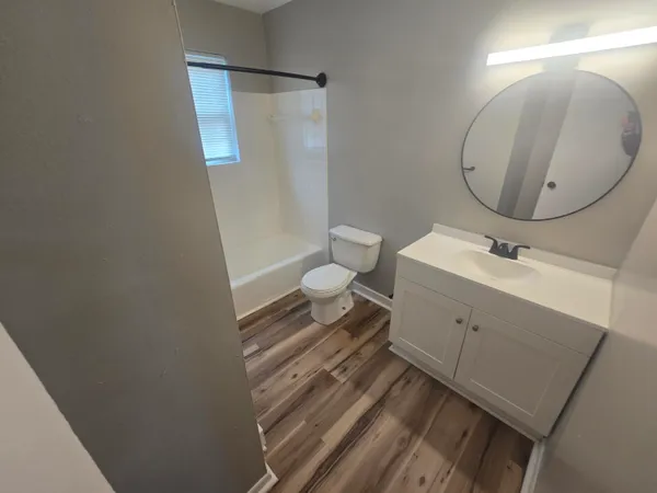 a bathroom with a sink mirror and toilet