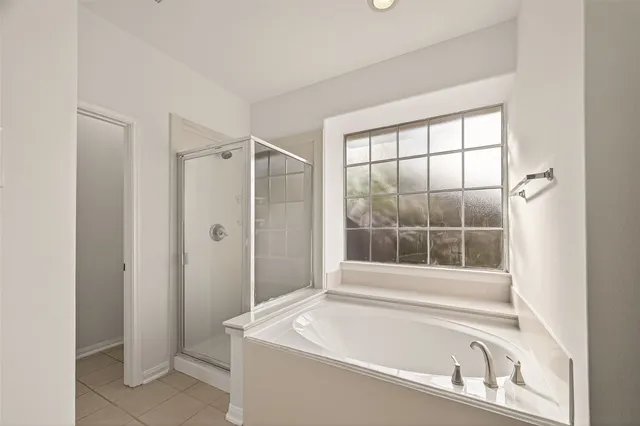 an empty room with a fan and a chandelier fan