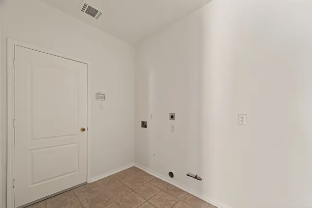 an empty room with windows and ceiling fan