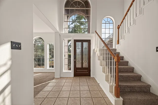 a view of an entryway with wooden floor and door