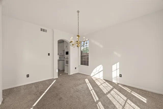 a view of a chandelier fan and entryway