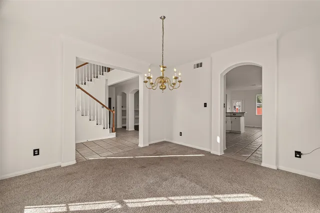 a view of a livingroom with wooden floor and a ceiling fan