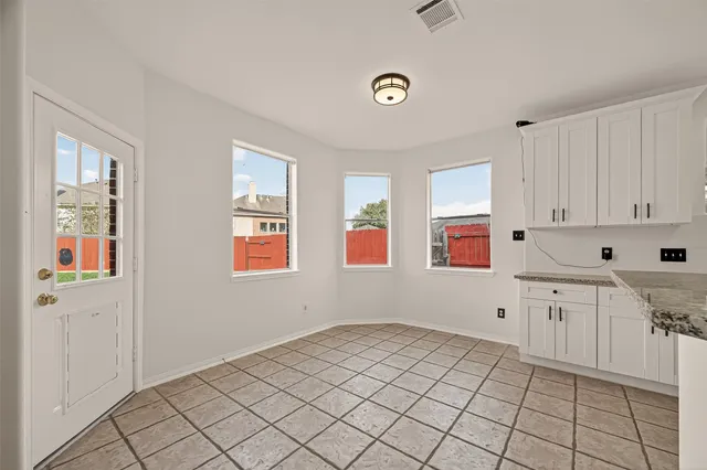 a bathroom with a tub a shower and a window