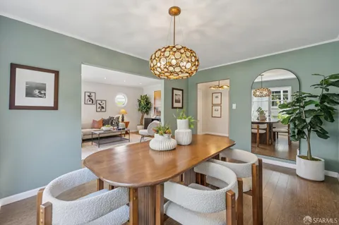 a kitchen with stainless steel appliances granite countertop a stove a sink and a white cabinets