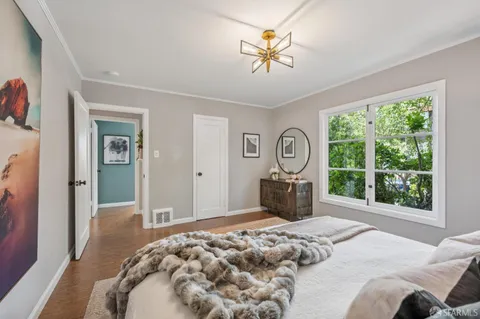 a bed room with a bed and a large window