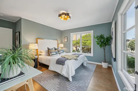 a view of a hallway with furniture and a potted plant