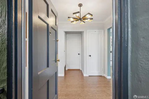 a view of a livingroom with hardwood floor and a ceiling fan