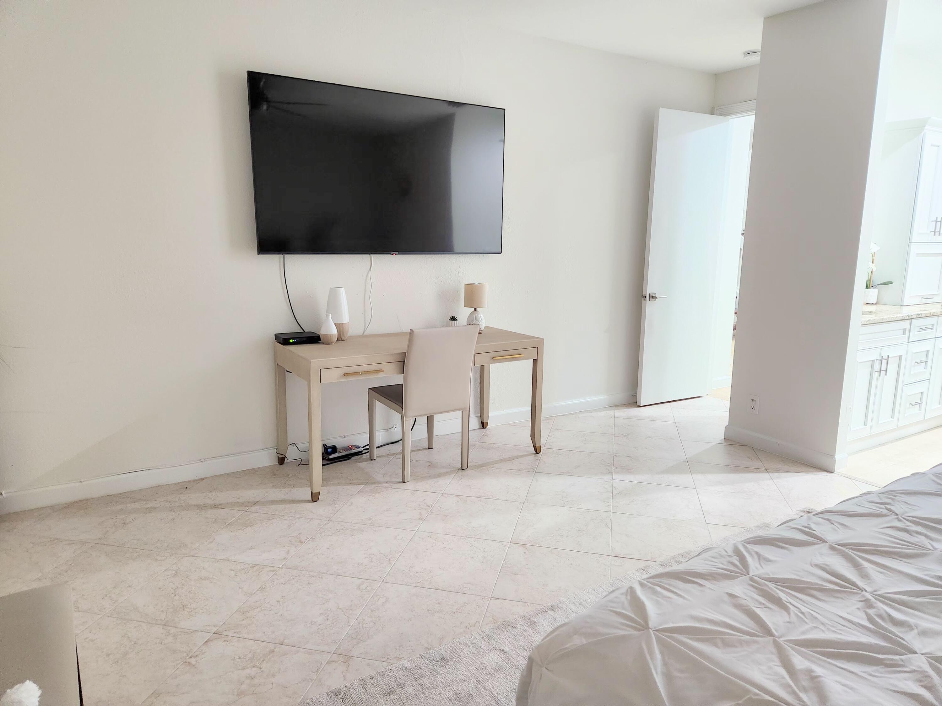 3567 Commodore Circle Delray Beach, FL 33483 - Photo 30 of 76 a view of a livingroom with furniture and a flat screen tv