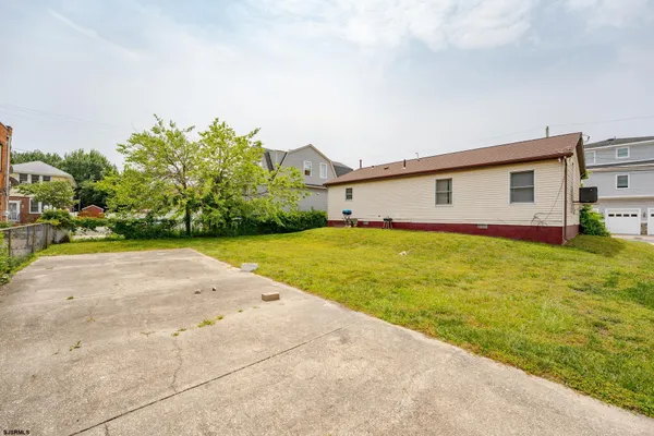 a front view of house with yard and outdoor seating