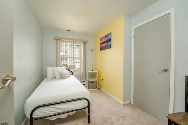 a bedroom with a bed and chair