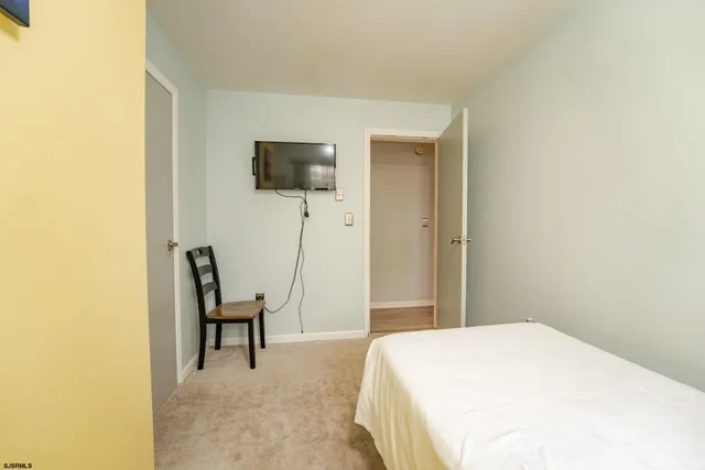 a bedroom with a bed and chair