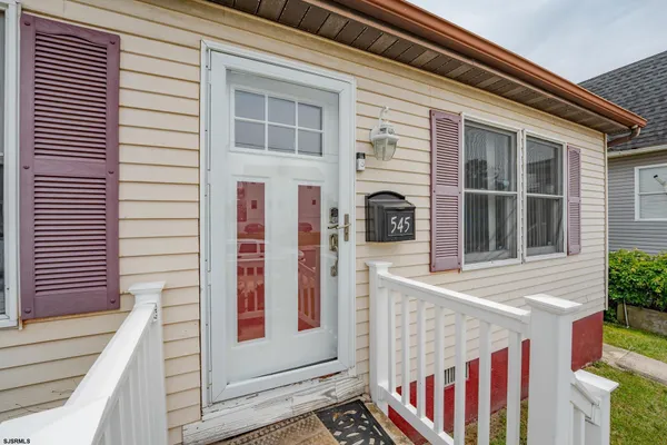 a yellow house with swimming pool in front of it