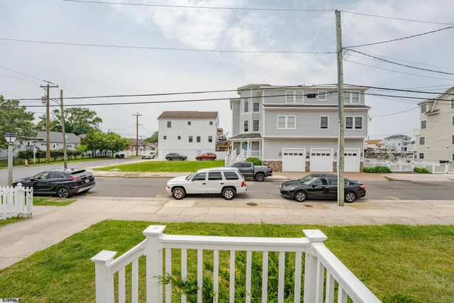 a yellow house with swimming pool in front of it