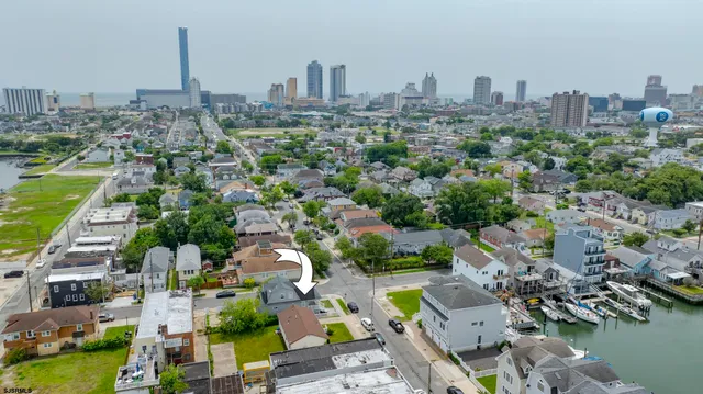 an aerial view of a house with a swimming pool outdoor seating and yard