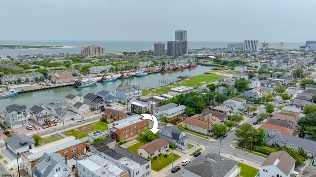 an aerial view of a house with a garden and lake view
