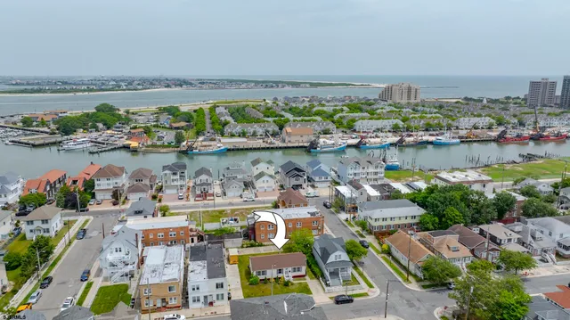 an aerial view of a house with outdoor space swimming pool and ocean view