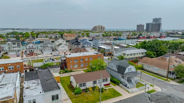 an aerial view of a house with garden space and street view