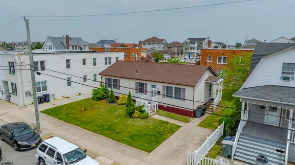 an aerial view of multiple houses with a yard