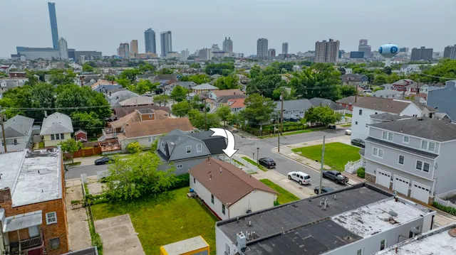 an aerial view of a house with garden space and street view
