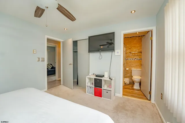 a bedroom with a bed and a view of bathroom