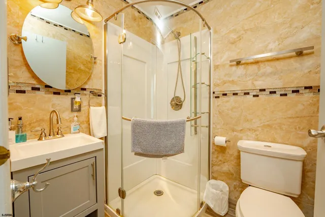 a bathroom with a sink toilet and shower