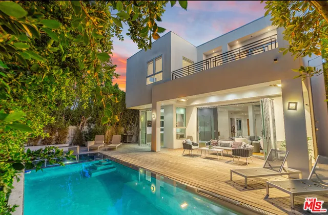 a view of a house with swimming pool and sitting area