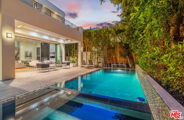 a swimming pool with outdoor seating and yard