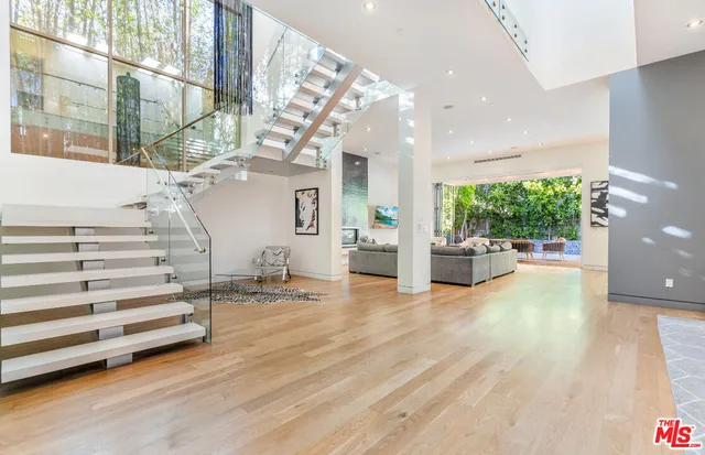 a view of entryway and hall with wooden floor