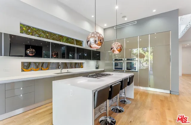 a kitchen with stainless steel appliances granite countertop a stove and cabinets