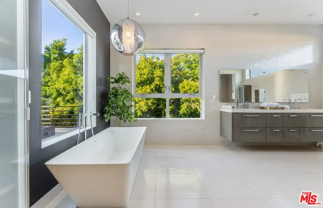 a large bathroom with a tub and sink