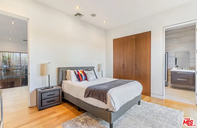 a bedroom with a bed and a couch