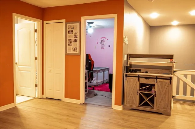 a bedroom with a bed and painting on the wall