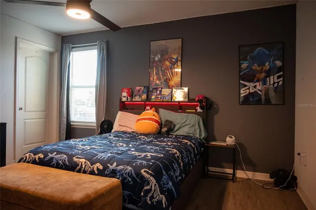 a living room with hard wood floors and a flat screen tv
