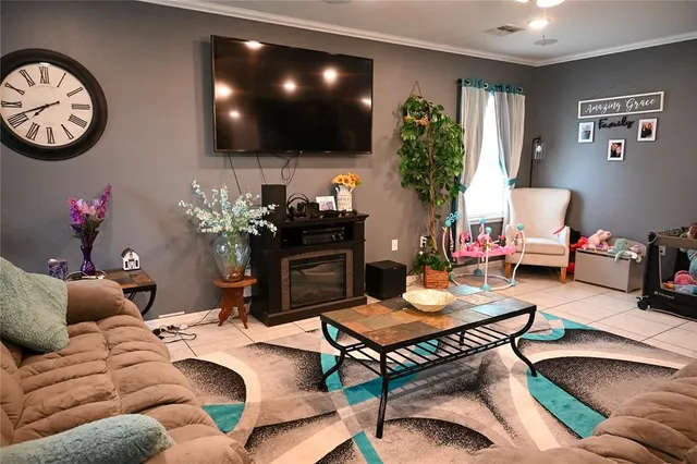 a living room with furniture a flat screen tv and a large window