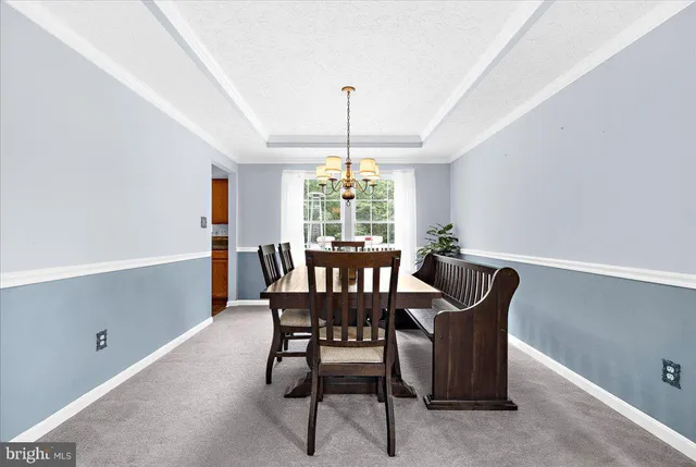 a view of an empty room with furniture and a window