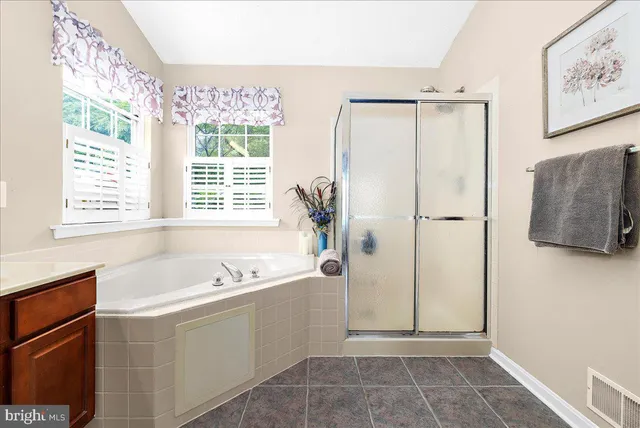 an empty room with window and ceiling fan