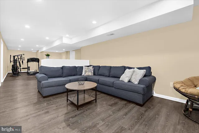 a view of a house with a small yard and fence